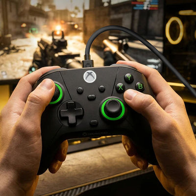 Drakong wired gaming controller in use with Hall Effect joysticks, black design with green accents, held while playing a first-person shooter game